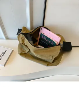 Spacious interior of khaki canvas tote showing storage for tablets and books