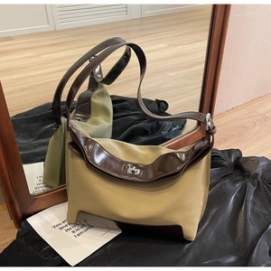 Detail of vintage khaki shoulder bag with brown leather trim and silver metal twist lock