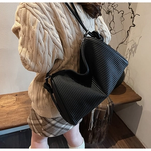 Close-up of black pleated texture detail on a stylish large capacity faux leather tote bag