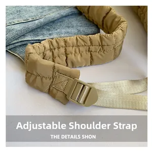 Detail of adjustable khaki quilted shoulder strap on a large puff hobo bag with nylon fabric