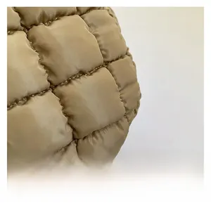 Macro detail of khaki quilted cloud bag showing premium water-resistant nylon texture
