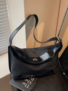 Retro black nylon tote bag with glossy trim and silver twist lock closure for women