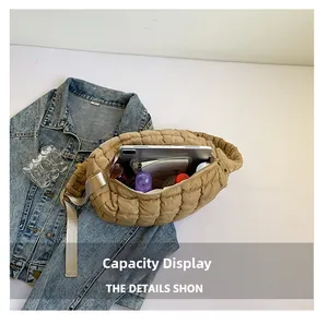 Spacious interior of beige quilted cloud bag showing tablet and cosmetics storage