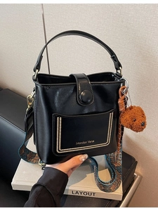 Retro schwarze Beuteltasche mit breitem Blumengurt und süßem braunem Bärenanhänger