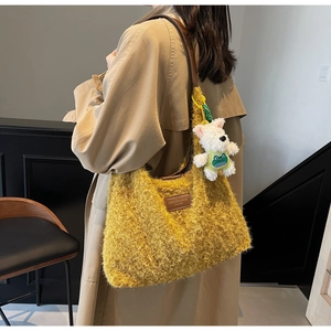 Yellow faux fur tote bag detail featuring brown leather patch and cute bear keychain