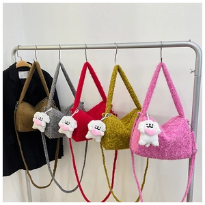 Detail view of five teddy plush crossbody bags in brown, grey, red, yellow and pink