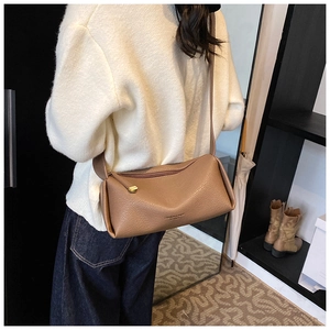 Brown litchi grain crossbody bag shown on model for size and proportion reference