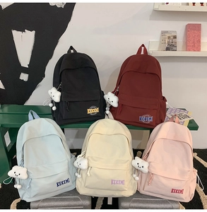 Group photo of five minimalist backpacks in various colors with plush cloud charms