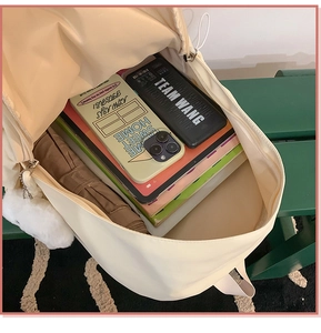 Detailed view of the cream white backpack interior showcasing large storage capacity