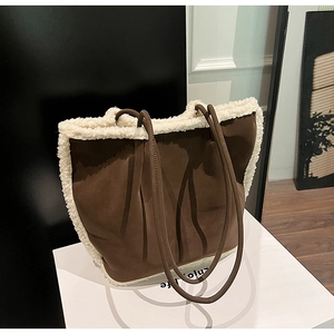 Close-up of deep brown suede tote bag with thick white faux shearling fur trim