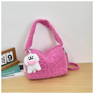 Detailed view of pink plush tote bag with a cute puppy pendant on a wooden table