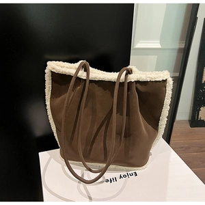 Close-up of brown suede tote bag with white fleece trim and long shoulder straps