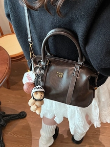 Retro dark brown baseball tote with PAN TOR logo and cute bear charm in cross-body view