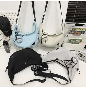 Multi-color dumpling crossbody bags in blue, white, black, and grey with mini pouches