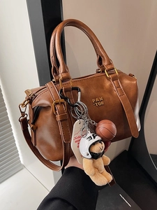 Vintage brown Boston style baseball handbag with plush bear charm and metallic branding