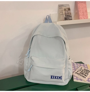 Detail of mint blue backpack side pocket with drawstring and KEKEMI brand label