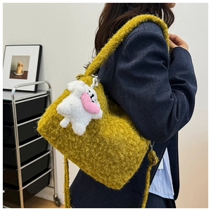 Detail of yellow plush tote bag with lamb wool texture and cute white puppy charm