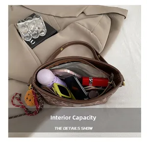 Internal capacity of leopard print bucket bag showing essentials like phone and umbrella