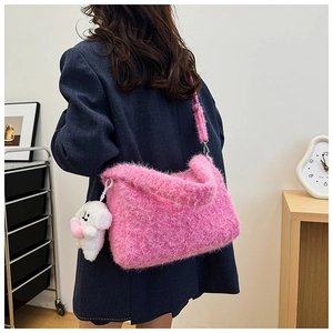 Pink faux fur tote bag with plush puppy charm shown on model in modern interior