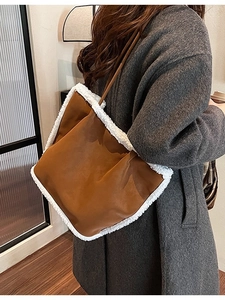 Brown suede tote bag with white faux shearling trim shown on model for daily commute