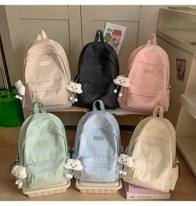 Flat lay view of pastel backpacks showing subtle rabbit prints and cloud pendants