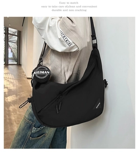 Detail of black crossbody bag with detachable coin purse and OF MY MIND strap