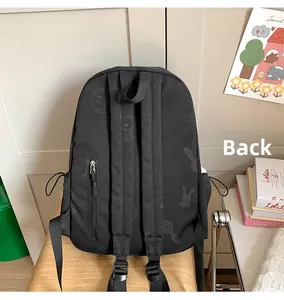 Detail of black backpack back panel with anti-theft zipper pocket and cartoon prints