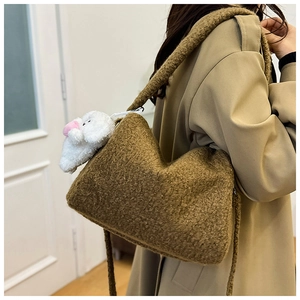 Detail of plush faux lamb wool tote bag in dark coffee with a cute white bunny charm