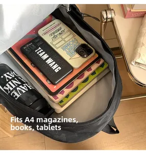 Detailed view of the large capacity interior of the black backpack fitting A4 items