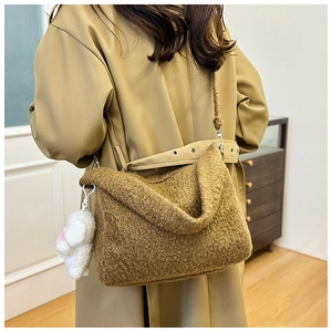 Brown teddy fleece tote bag with a cute sheep plush charm shown as a crossbody bag style