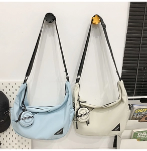 Close-up of crescent dumpling bags with adjustable straps and hanging mini coin purses