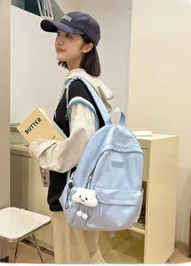 Light blue water-resistant backpack featuring cloud plush pendant and patterned surface