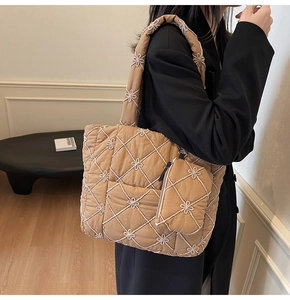 Quilted khaki tote bag with white floral embroidery and matching small pouch detail