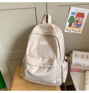 Detail of beige casual backpack with cute graphic prints and soft nylon fabric texture