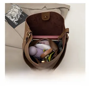Vertical view of the large capacity interior of a dark brown pebble leather bucket bag