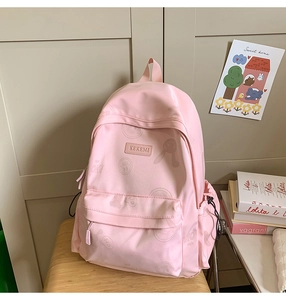 Detail of pink backpack with cartoon rabbit prints and KEKEMI brand leather label