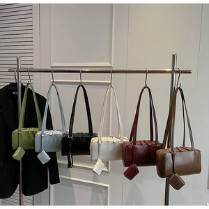 Detail view of colorful minimalist faux leather shoulder bags with matching coin pouches