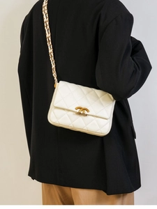Elegant white quilted leather shoulder bag with gold chain strap and metallic closure