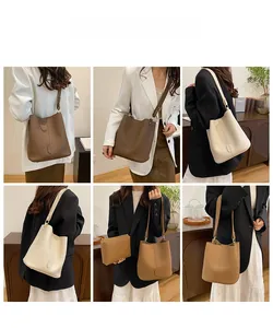 Detail view of leather bucket bag with matching inner pouch and litchi texture finish