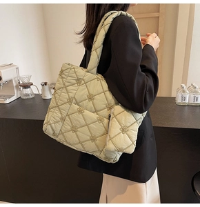 Detail of light green quilted tote bag with floral embroidery and matching coin purse