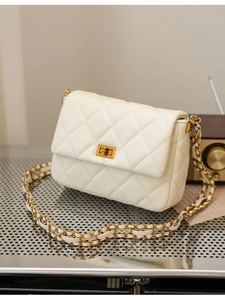 Elegant cream quilted shoulder bag with gold chain strap and turn-lock closure