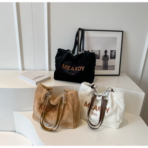 Three plush faux fur tote bags in black, brown, and white with elegant logo embroidery