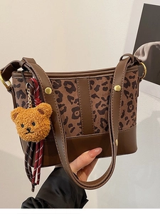 Fashionable leopard print bucket bag with brown PU leather trim and plush bear charm