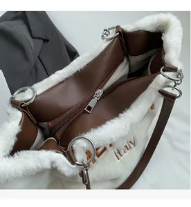 Detail of white plush tote bag with smooth metal zipper and Italy embroidery