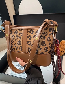 Fashionable leopard print bucket bag with brown leather trim and cute bear charm