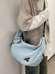 Light blue nylon crossbody dumpling bag with adjustable strap and small round pouch