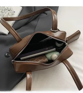 Interior view of the dark brown leather shoulder bag showing large storage capacity