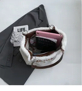 Top view of spacious interior with brown lining in a plush white tote bag