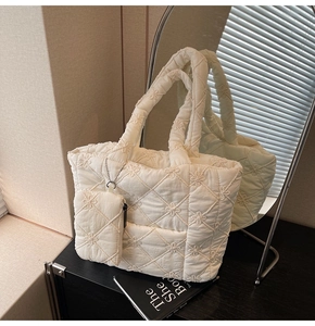 Detail of floral quilted puffer tote bag with matching mini pouch and silver chain link