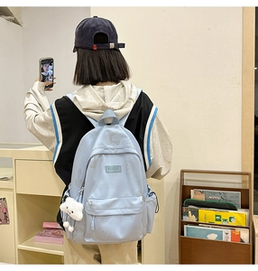 Light blue school backpack with cute rabbit prints and plush cloud charm on back view